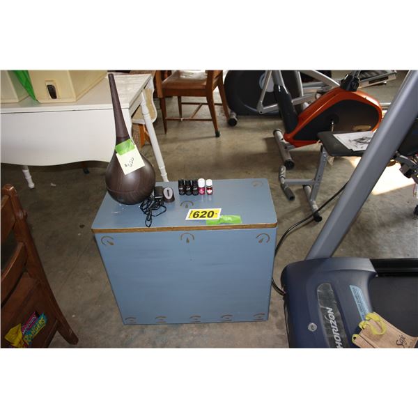 wooden clothes hamper and essential oil diffuser