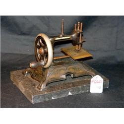 CHILD'S VICTORIAN SEWING MACHINE ON MARBLE BASE