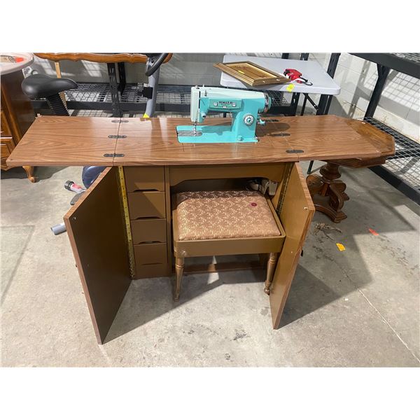 White sewing machine in cabinet with stool