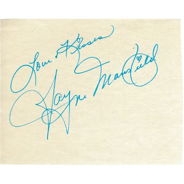 In 1957, actress Jayne Mansfield signs autographs as she