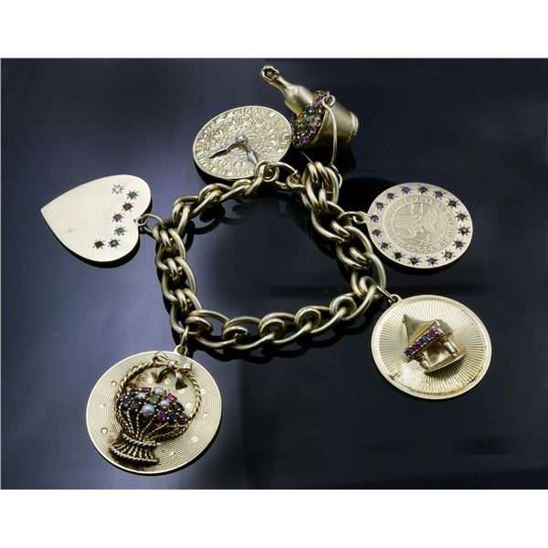 HEAVY 14KT CHARM BRACELET AND CHARMS.