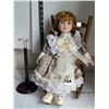 Image 6 : Beautiful porcelain doll on removable stand, with wooden rocking chair.