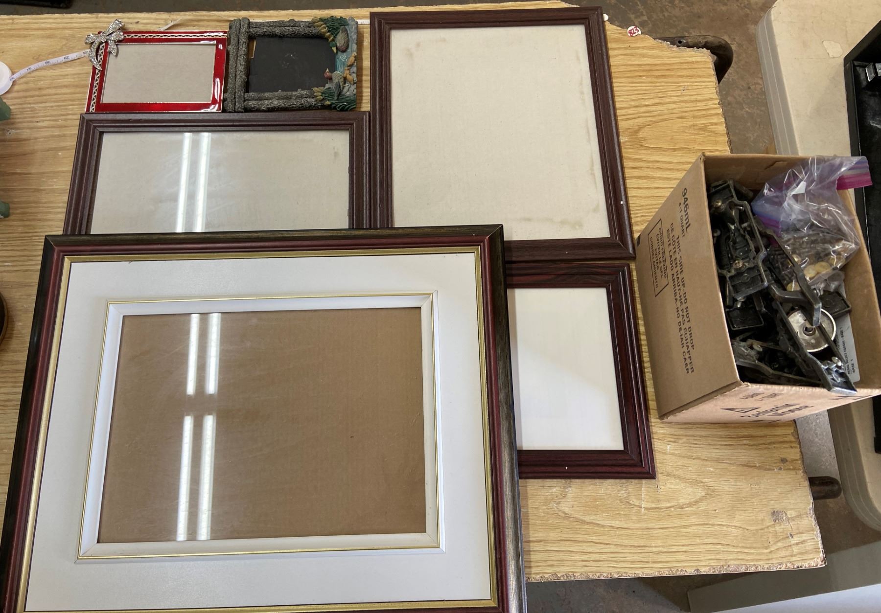 1 Box of Picture Frames and Cabinet Handles - Schmalz Auctions