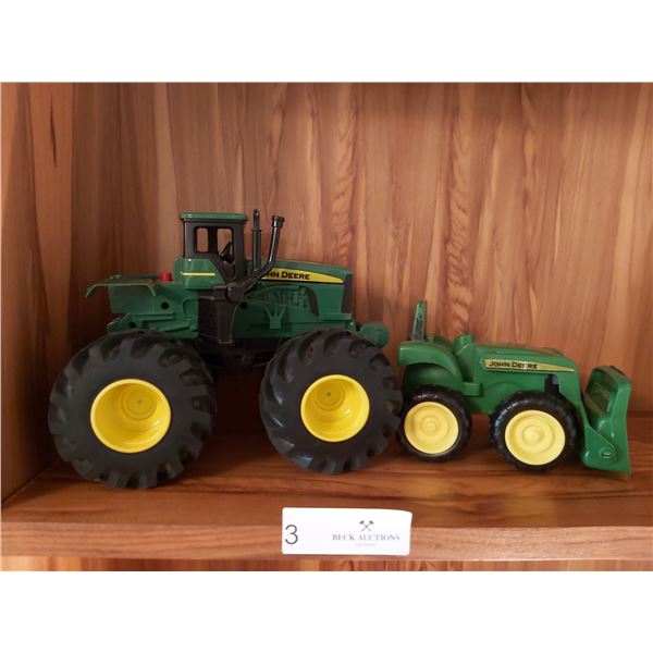 2 John Deere Plastic Collectable Tractors larger one is 9 Inches Long x 7 Inches High