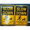 Image 1 : Lot of 4 "Slow Down - Kids & Pets at Play" Metal Signs