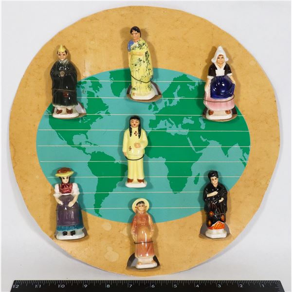 7 CERAMIC DOLLS OF THE WORLD ON CARBOARD DISPLAY