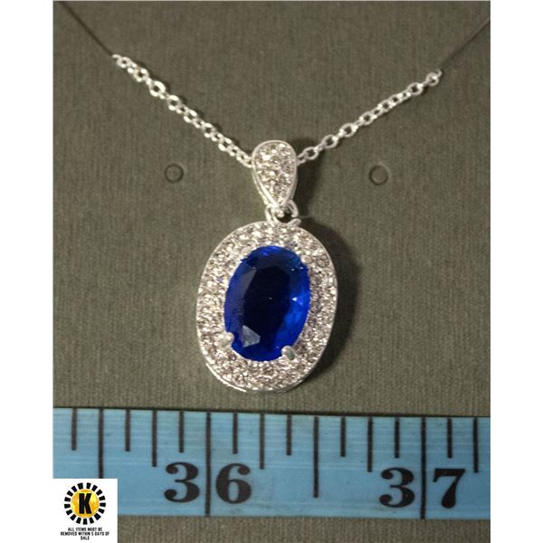 #121 10 X 14 MM OVAL BLUE STONE SURROUNDED BY 2