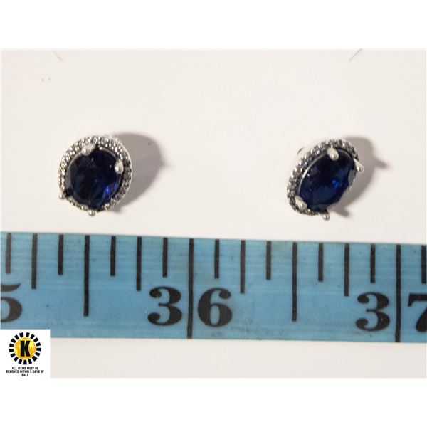 #106 6 X 8 MM BLUE OVAL STONE WIT A HALO