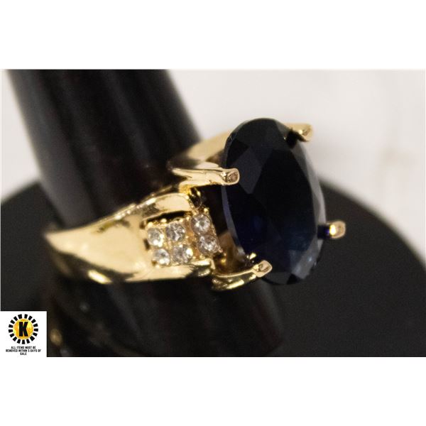 #97 12X16 MM OVAL BLUE STONE WITH 6 CLEAR STONES