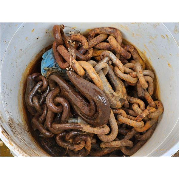 Pail of various heavy chains, with hook
