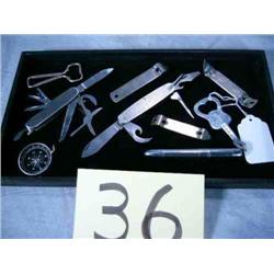 2 pocket knives, 4 bottle openers, Compass, penlight