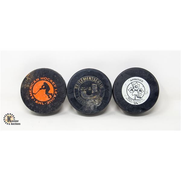 THREE VINTAGE AHL HOCKEY PUCKS