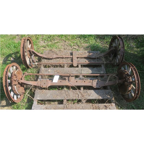 Pair of Antique axles with Metal & wood wheels 60” long & 19.5” diameter