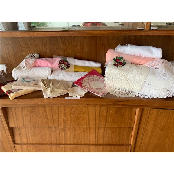 Assorted table coverings, protector pads, place mats, napkins and poinsettia table runner and napkin