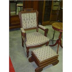 WALNUT FRAMED CHAIR AND OTTOMAN FOOT STOOL (HAS STORAGE); WITH CARVINGS; STAINS ON SEAT OF CHAIR