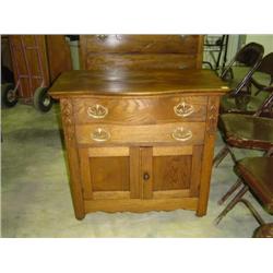 OAK WASH STAND; 2 DRAWERS OVER BLIND DOORS; CURVED DRAWER & TOP; MATCHES DRESSER; 30 1/2W X 16 1/2D 