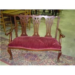 SETTEE; RED VELVET SEAT; WALNUT FRAMED WITH CARVED BALL AND CLAW FEET ON FRONT LEGS; 48 INCHES