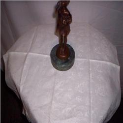 Bronze state with marble base of boy playing flute