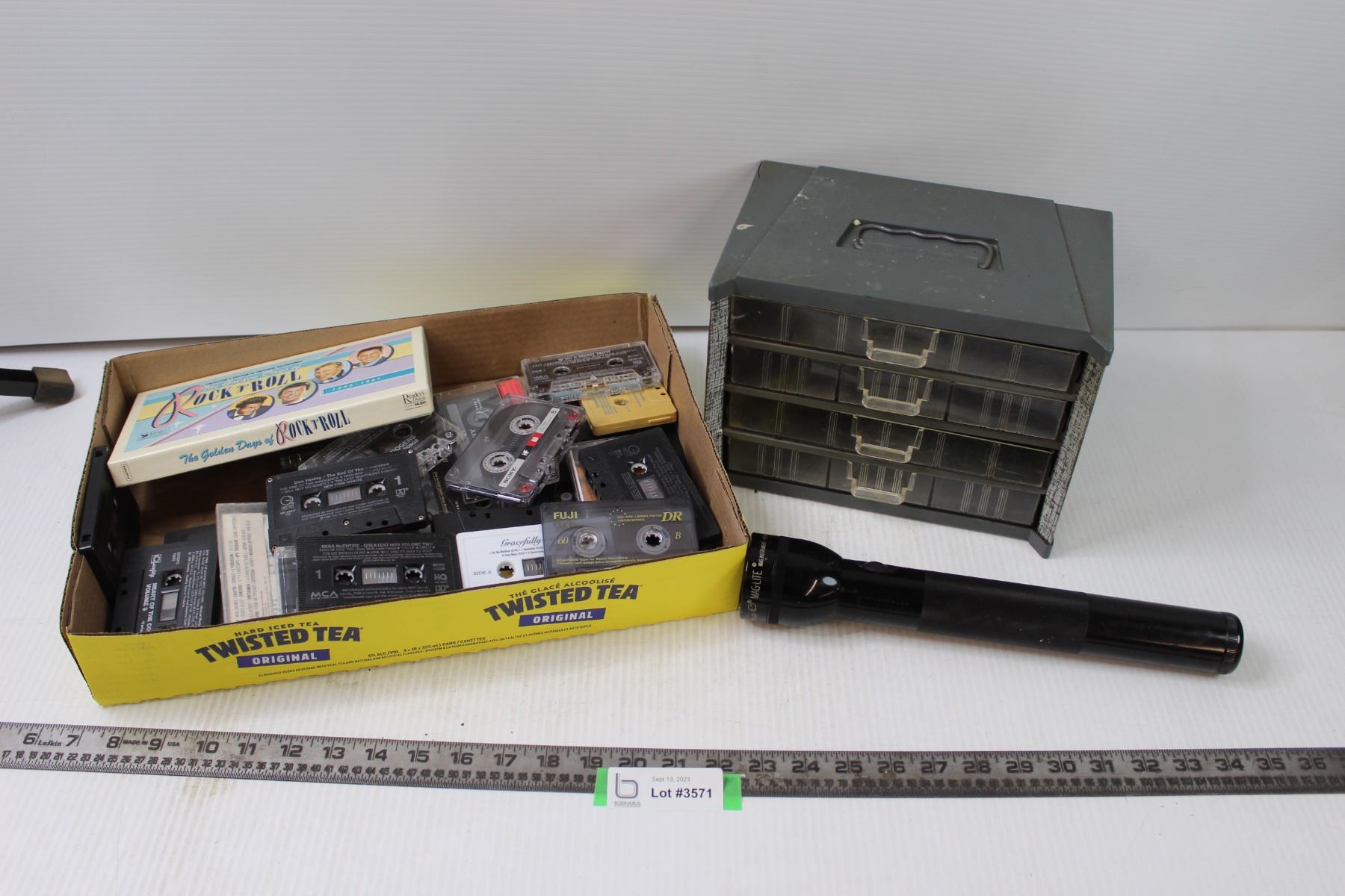 Storage Box, Flashlight, and Assorted Cassette Tapes