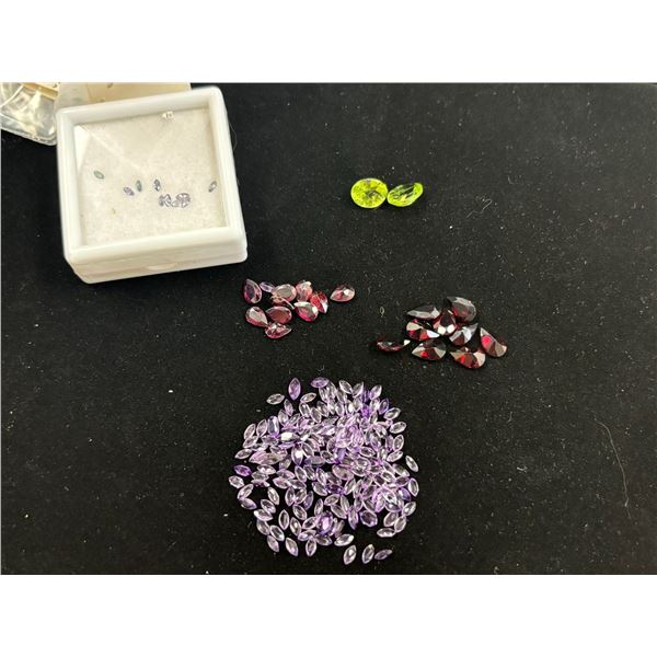 ASSORTED GEMS INCLUDING; AMETHYSTS, GARNETS, & 2 PERIDOTS. VARIOUS SIZES AND SHAPES