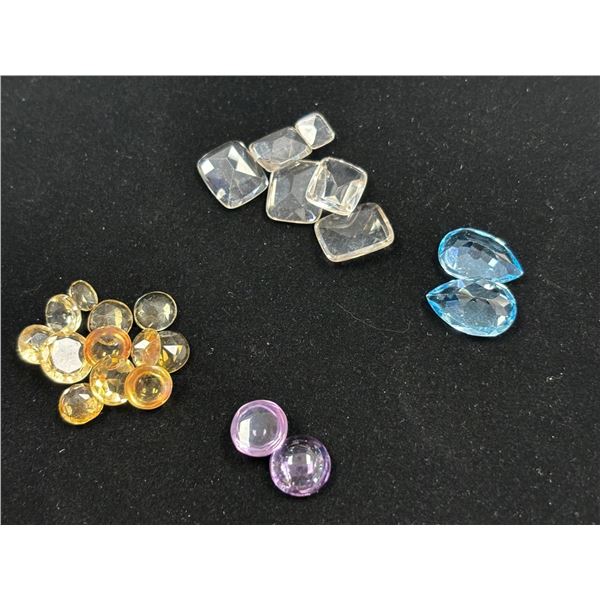 ASSORTED GEMS INCLUDING; 2 BLUE TOPAZ, 18 CITRINE, & 2 AMETHYSTS. VARIOUS SIZES AND SHAPES