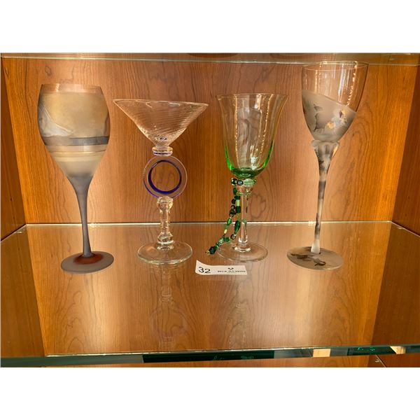 Three Wine Glasses And One Martini Glass