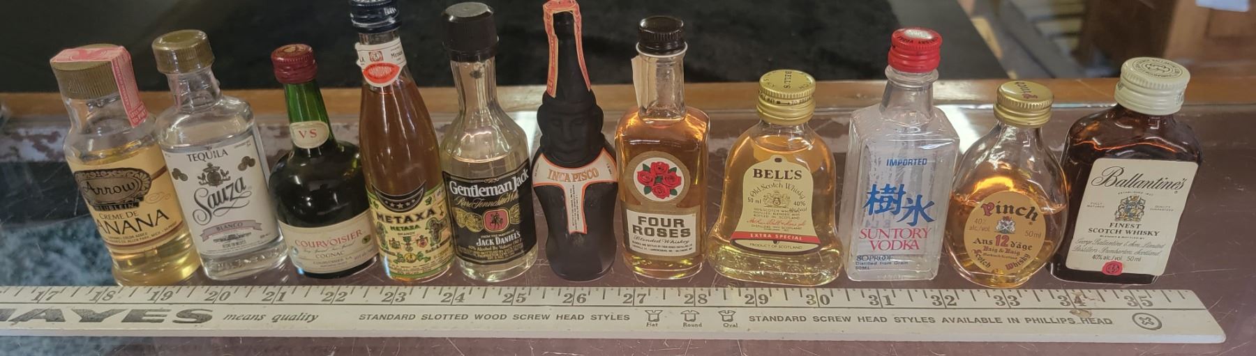 11 mini collectible liquor bottles - most full, some partial or empty ...