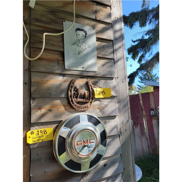 GMC hub cap, decorative horse shoe & Betty Boop sign