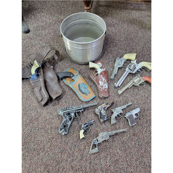 Toy cap guns, holsters and pot with lid