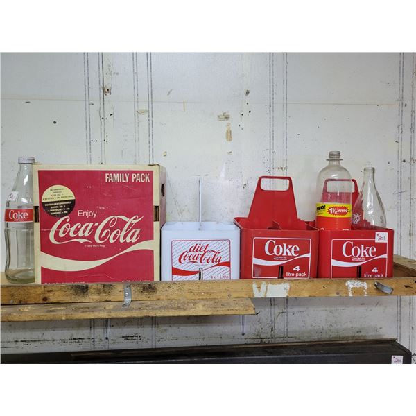 3 plastic coke carriers and 1 cardboard with 3 bottles