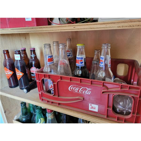 coca cola plastic case and assorted bottles