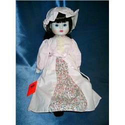 porcelain doll in pink dress