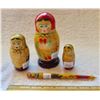 Image 1 : variety of Matryoshka wooden dolls with unusual pen