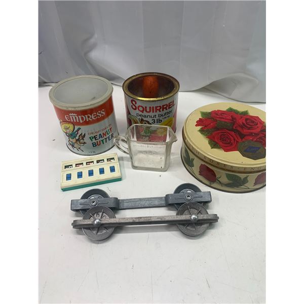 Tins, measuring cup, gambling machine and clothes line ass.