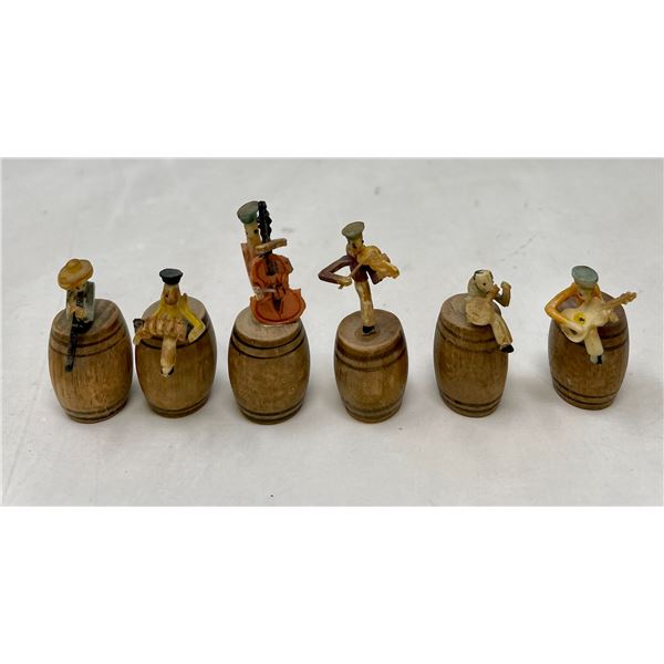 Miniature People Playing on Barrels