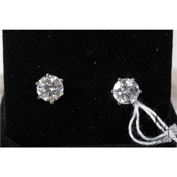 Pair of sterling silver with white gold overlay solitaire earrings, each set with 1.00 ct moissanite