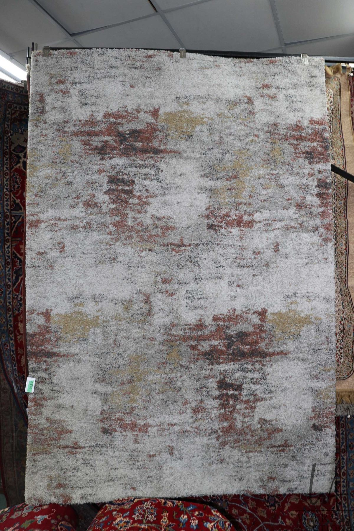 63x90in Rug Urban Barn area rug in mottled earth tones, 63