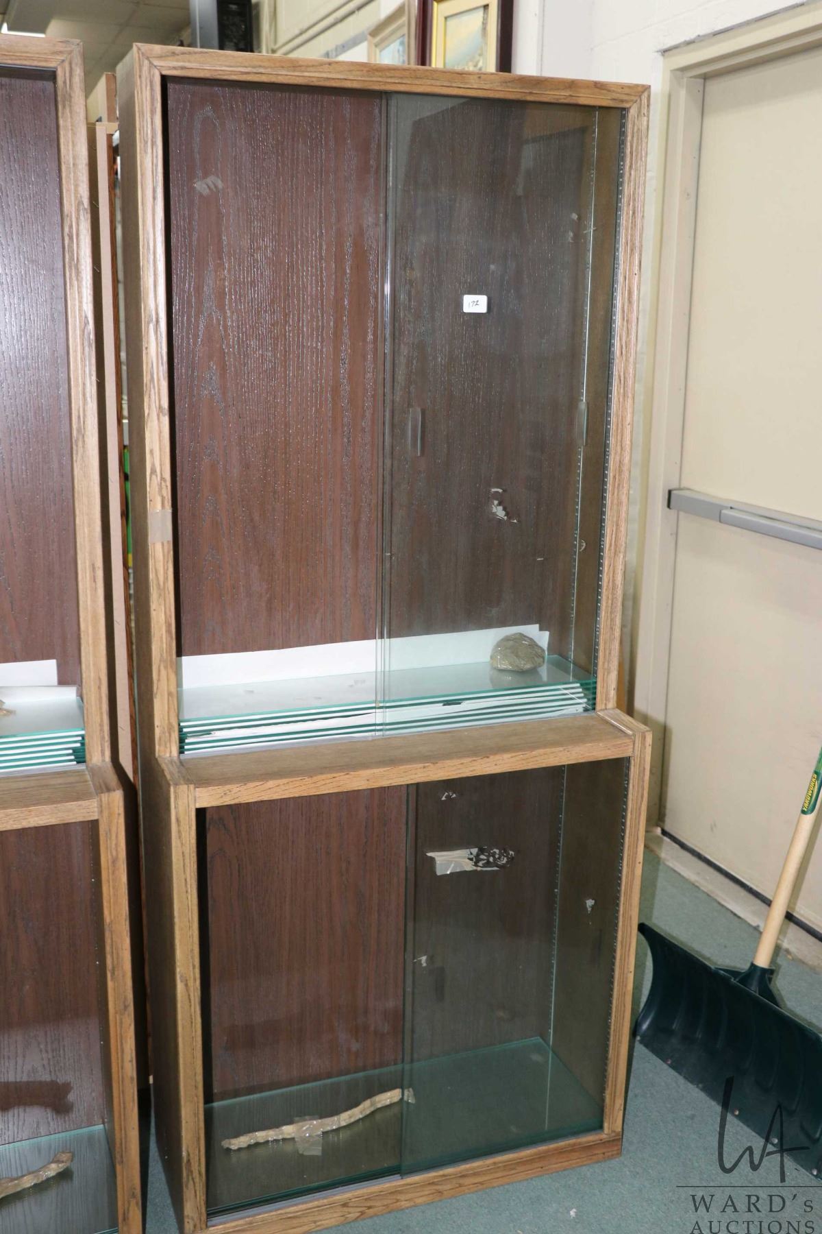 Wood and glass shallow display unit, divided into three parts, each ...