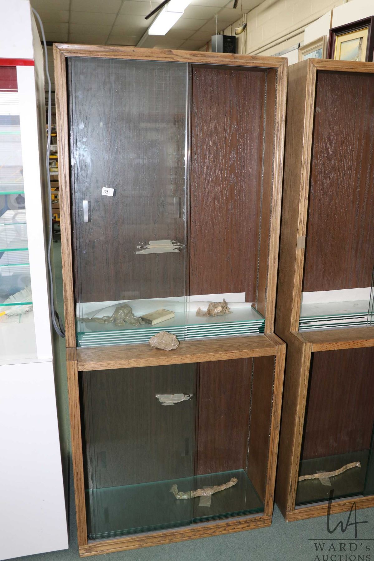 Wood and glass shallow display unit, divided into three parts, each ...