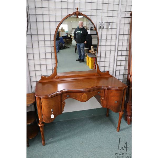 Mid 20th century mirrored vanity with two curved doors and single drawer on reeded supports, 64" in 