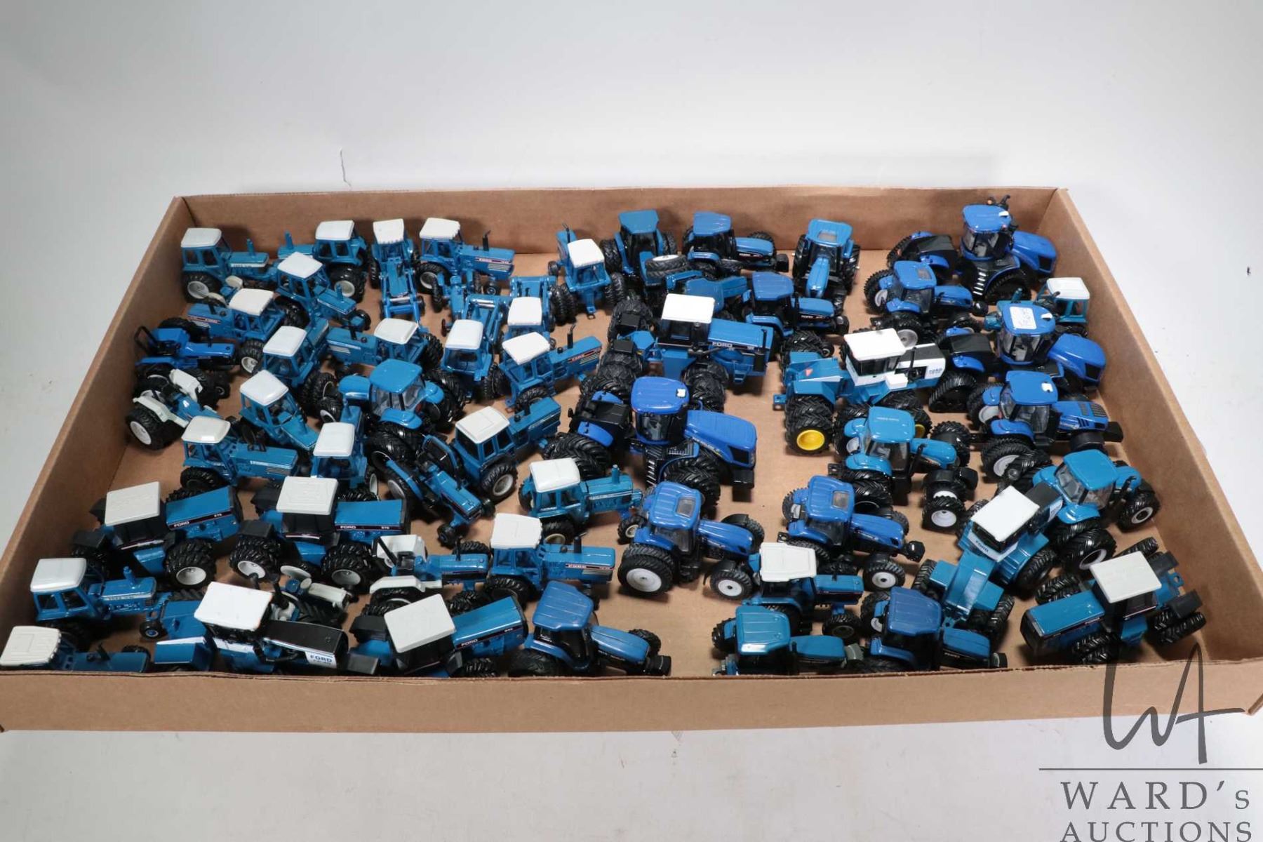 Selection of 1/64 scale Ertl diecast Ford and New Holland tractors