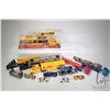 Image 1 : Six 1/64 scale diecast semi trucks including two CAT racing, Kodak racing, dump truck, car carrier, 