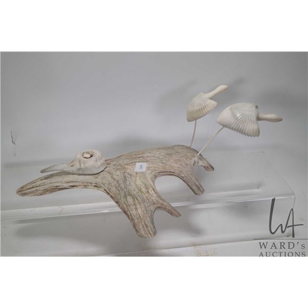 Inuit carved antler and bone sculpture of a two birds in flight and their nest, 14" in length and si