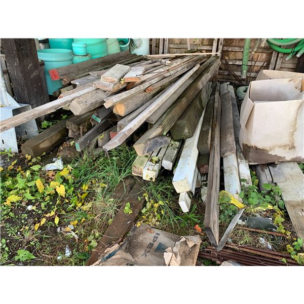 LARGE STACK OF ASSORTED LUMBER INCLUDING BEAMS & WEATHER TREATED POSTS