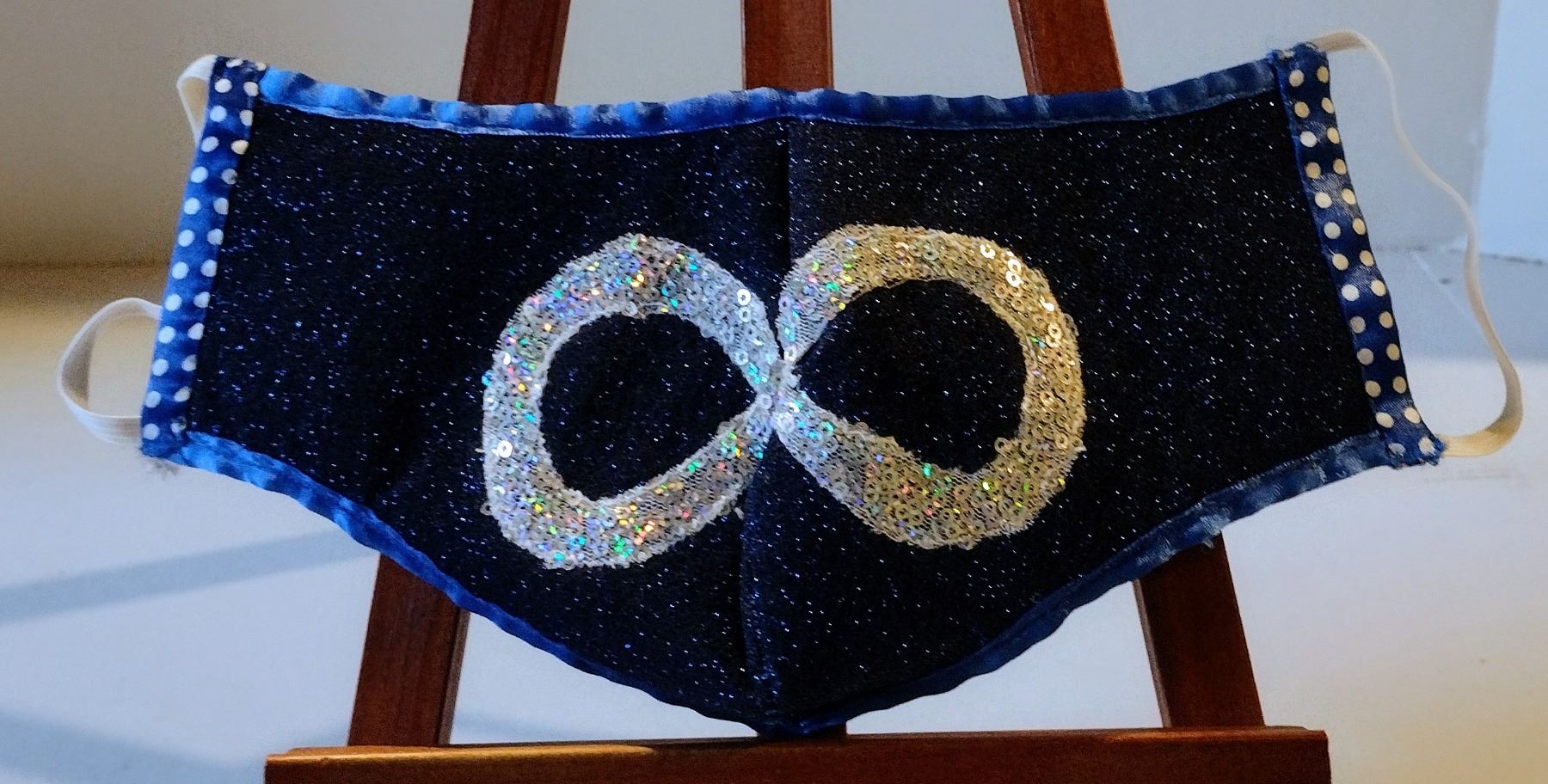 Infinity Mist Mask Mask with a Metis infinity symbol on a blue background (not used ...