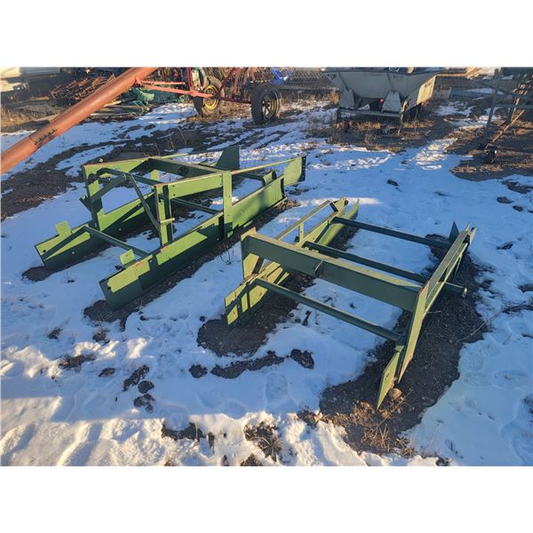 two green conveyor farming implements