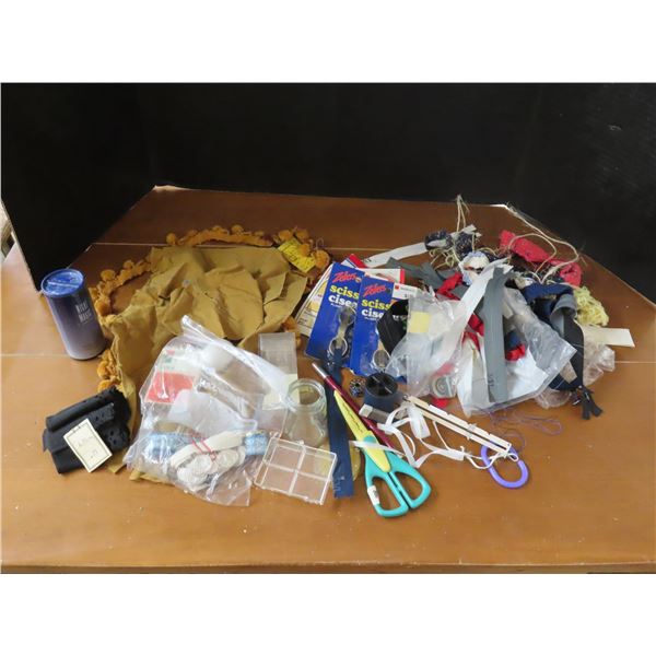 Assorted sewing items - scissors, zippers, fabric pieces, etc.