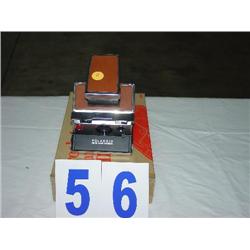 POLARIOD CAMERA WITH A BROOKSTONE AUTOMATIC CD CLEANER