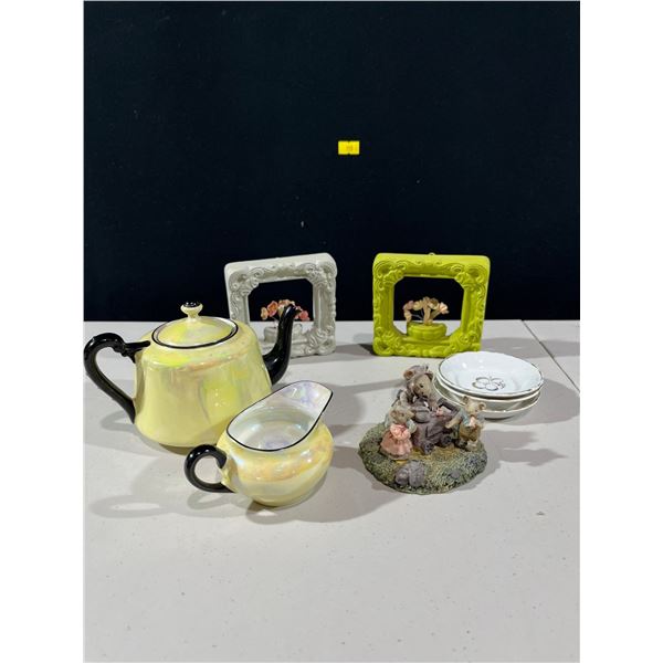 Variety of decorative items includes ceramic frames, teapot and creamer