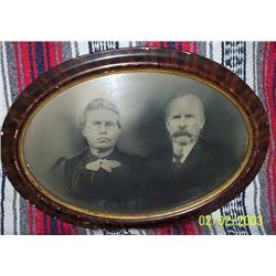 MAN AND WOMAN IN OVAL GLASS